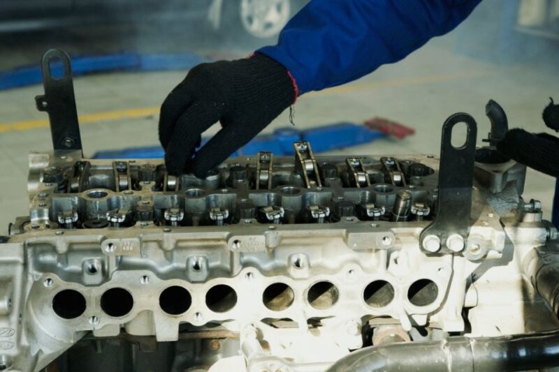 Technician rebuilding an engine cylinder head