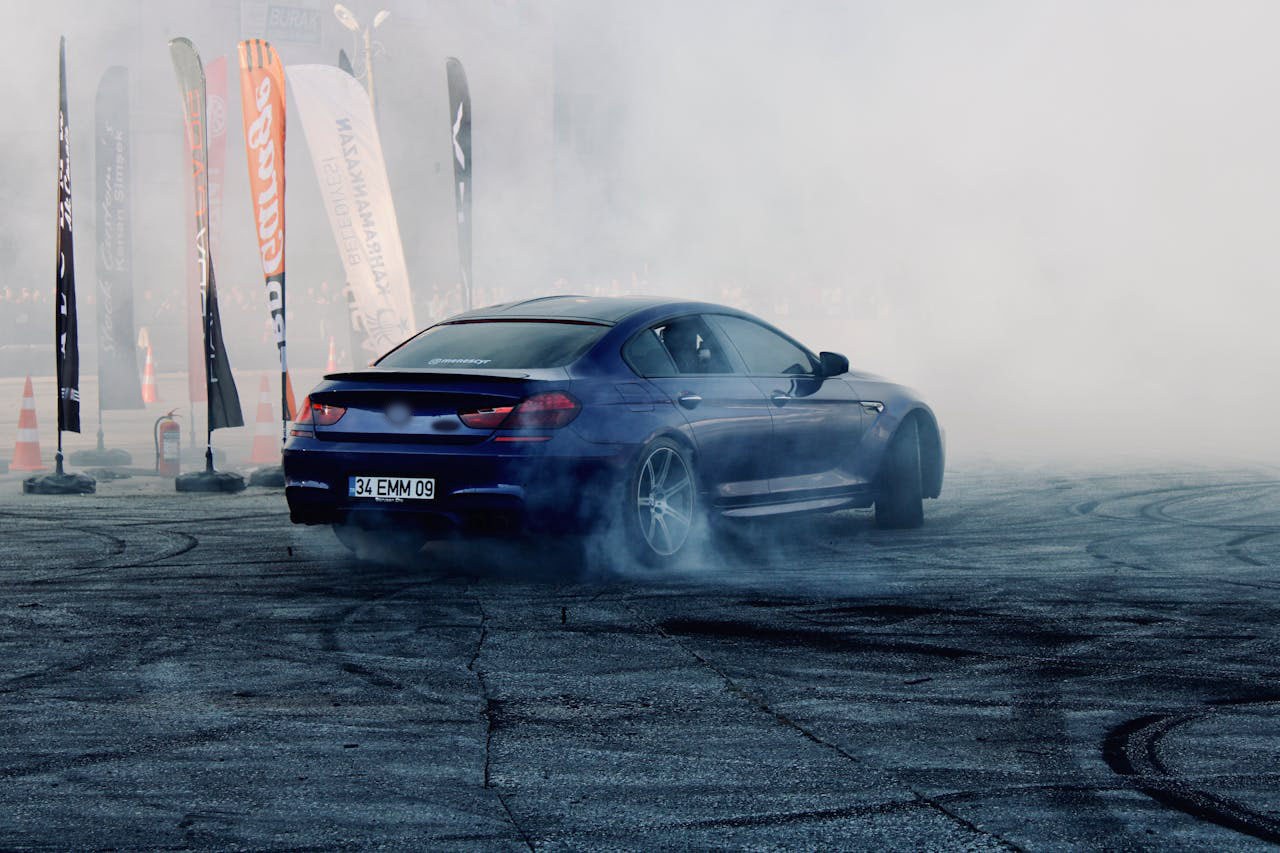 Sports coupe drifting in tire smoke